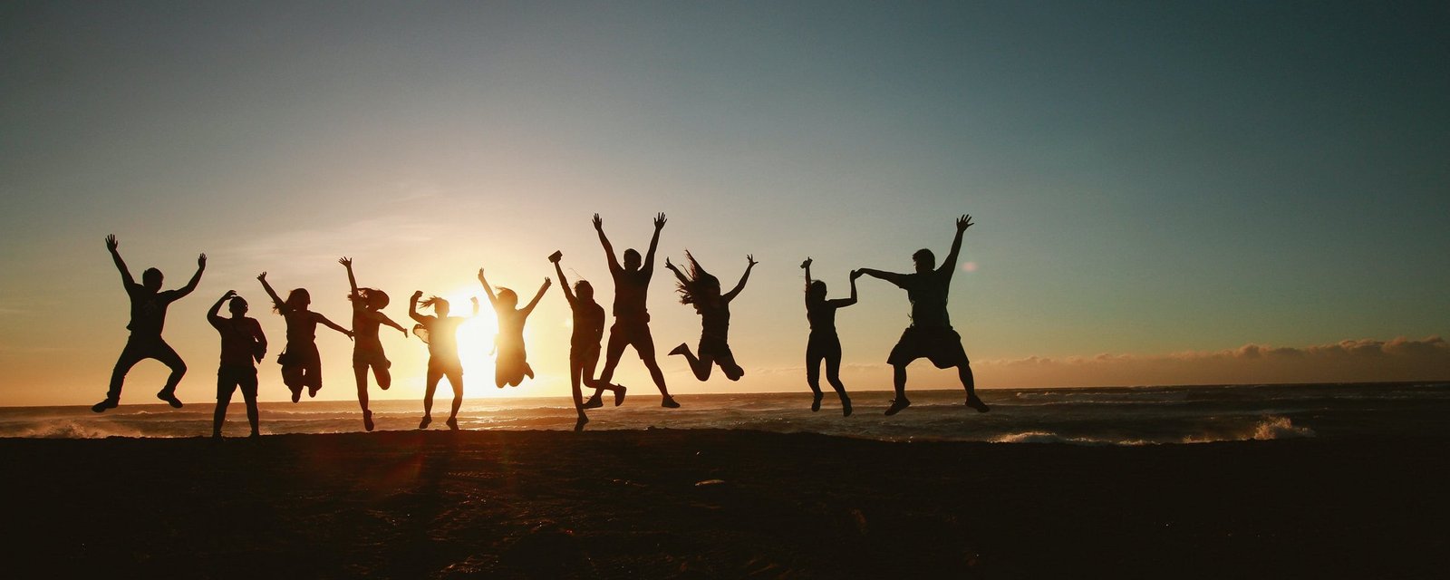 silhouette-photography-of-group-of-people-jumping-during-445